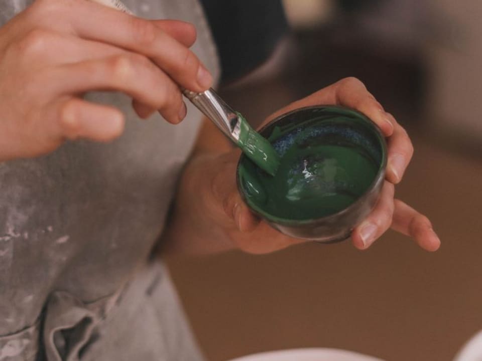 Green glaze mixed in a bowl, ready for the brush